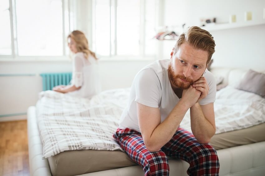 unhappy couple on bed